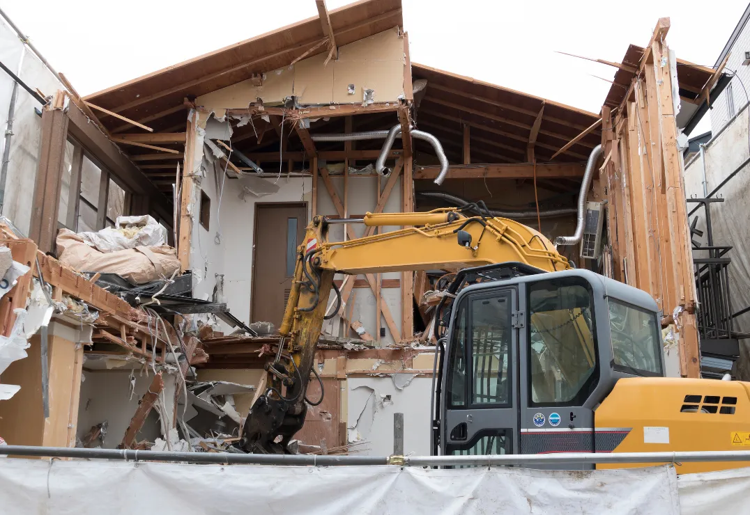 Residential demolition with excavator removing house in Dallas TX