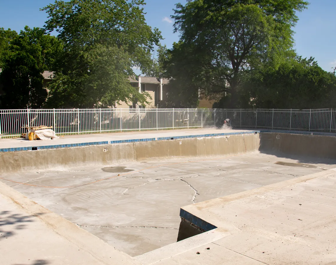 Pool demolition in Dallas TX with inground swimming pool removed and site prepared for backfill