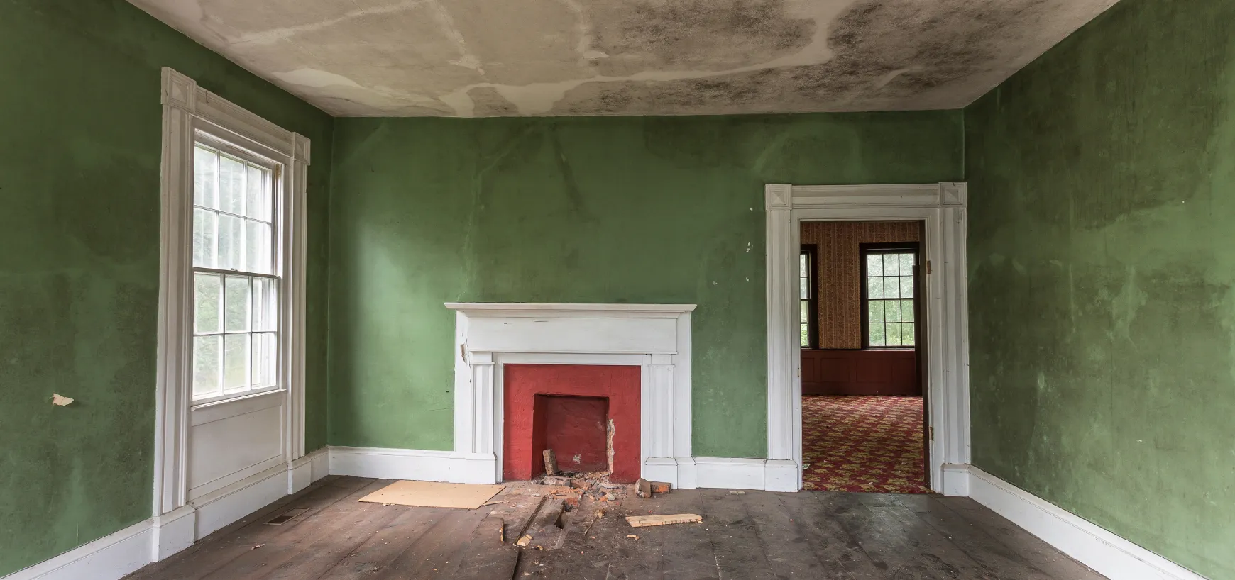 Old residential interior before demolition in Dallas TX showing outdated finishes and damaged walls
