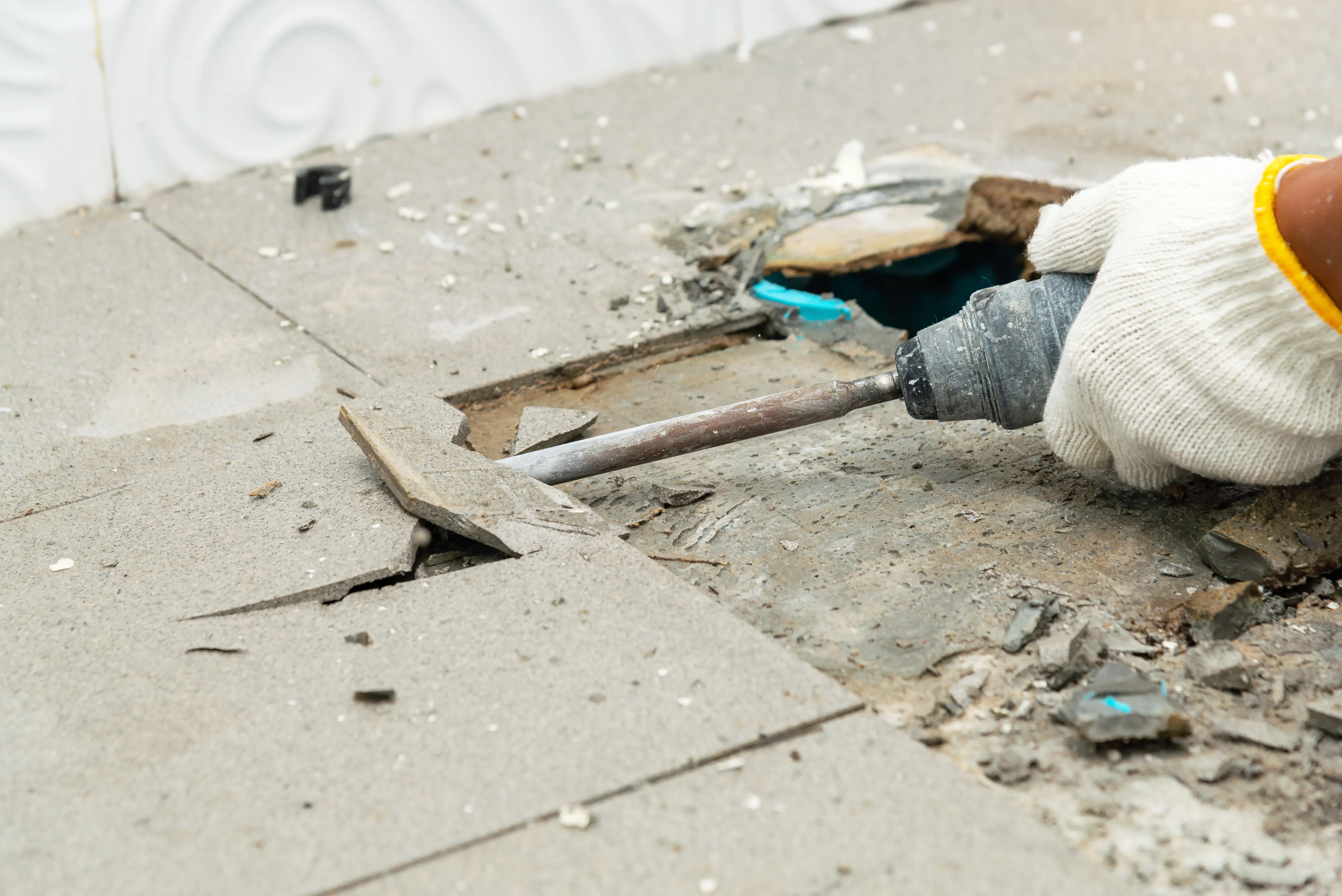 Commercial interior demolition in Dallas TX with floor tile removal using jackhammer during office renovation project