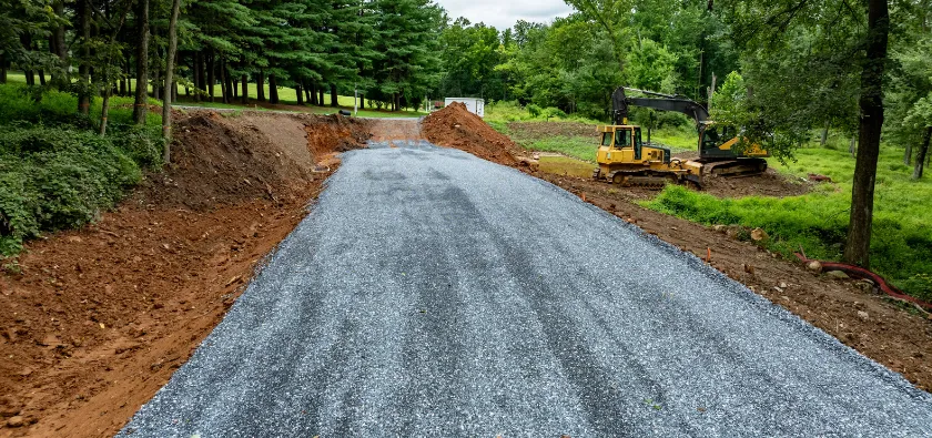 Land clearing in Dallas TX showing cleared land and gravel road during site preparation