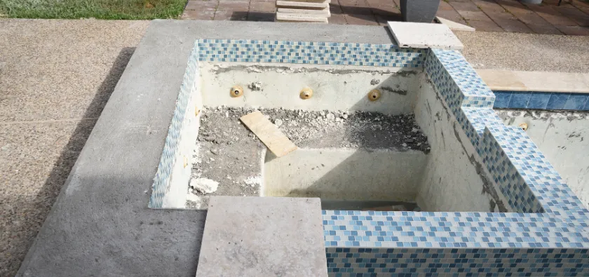 Pool demolition in Dallas TX showing tile and concrete breakup during inground pool removal