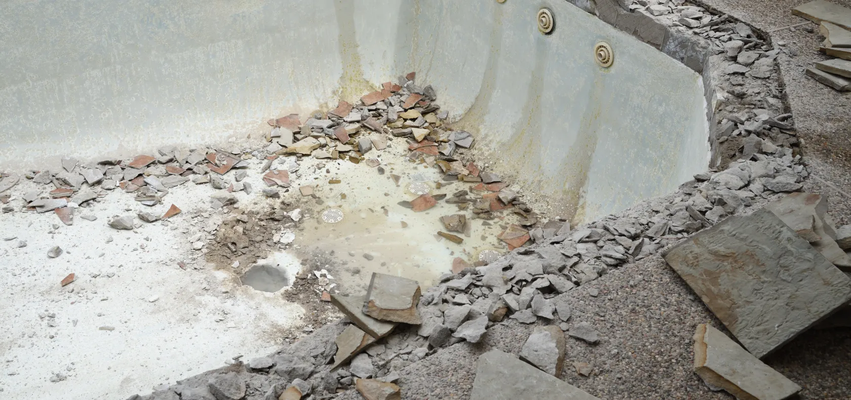 Pool demolition in Dallas TX showing inground pool removal and debris cleanup